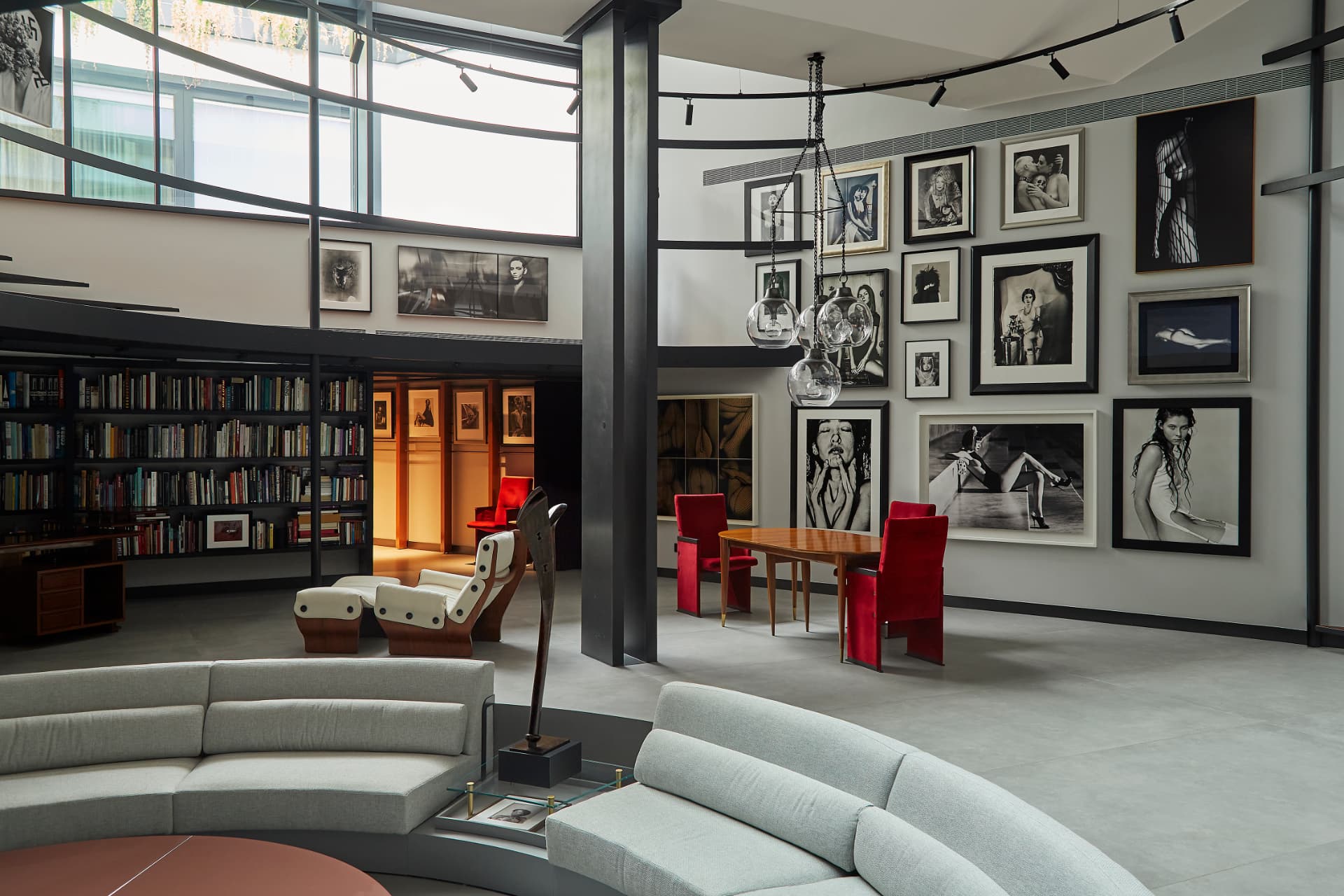 Private collector's loft with a salon-style wall of framed photographs